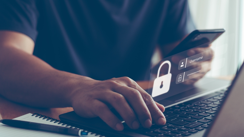 Man inputting login information on laptop