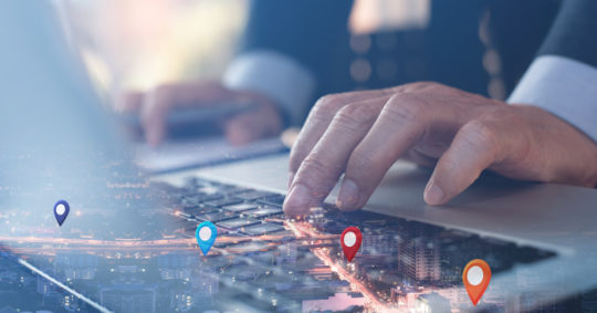 Man searching computer with map icons
