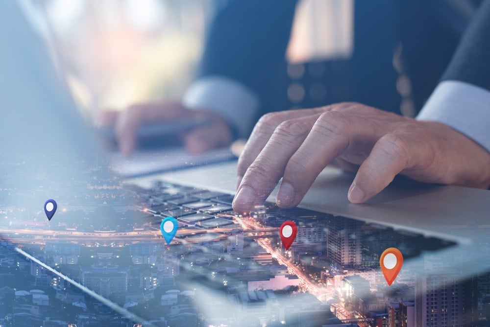 Man searching computer with map icons