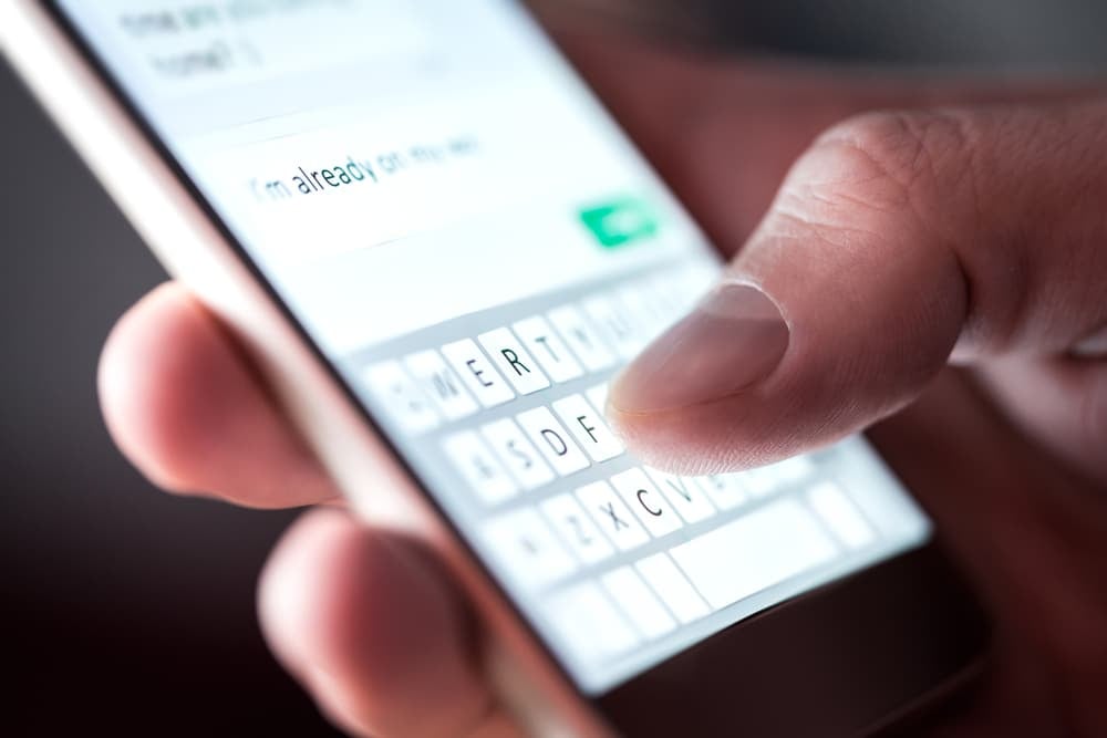 Close-up of a man sending a text message on smartphone