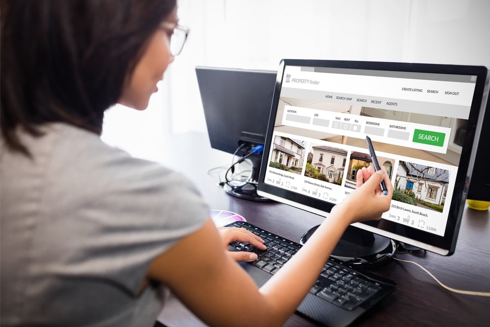 woman browsing property websites on computer