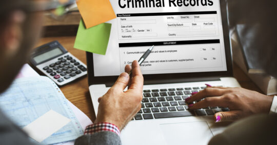business people reviewing criminal records forms