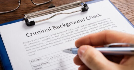 a person filling out a criminal background check form