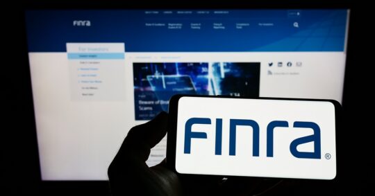 hands holding cellphone that says finra