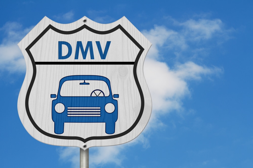 a blue car DMV sign
