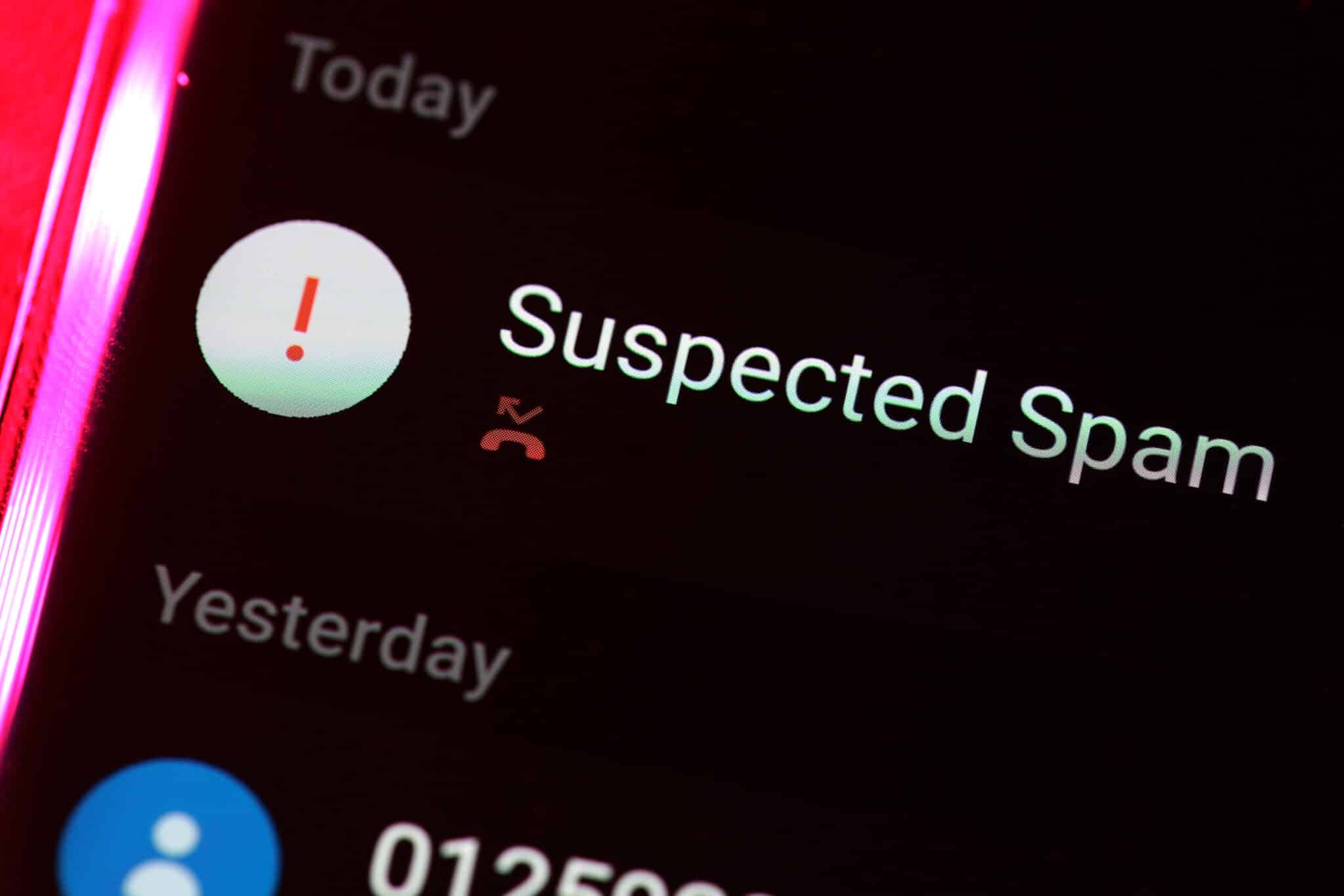 closeup of suspected spam caller alert on cell phone
