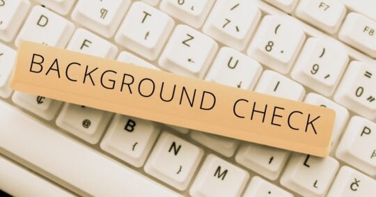 background check text caption on keyboard