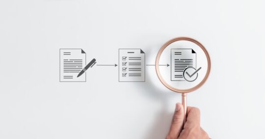 magnifying glass above documents